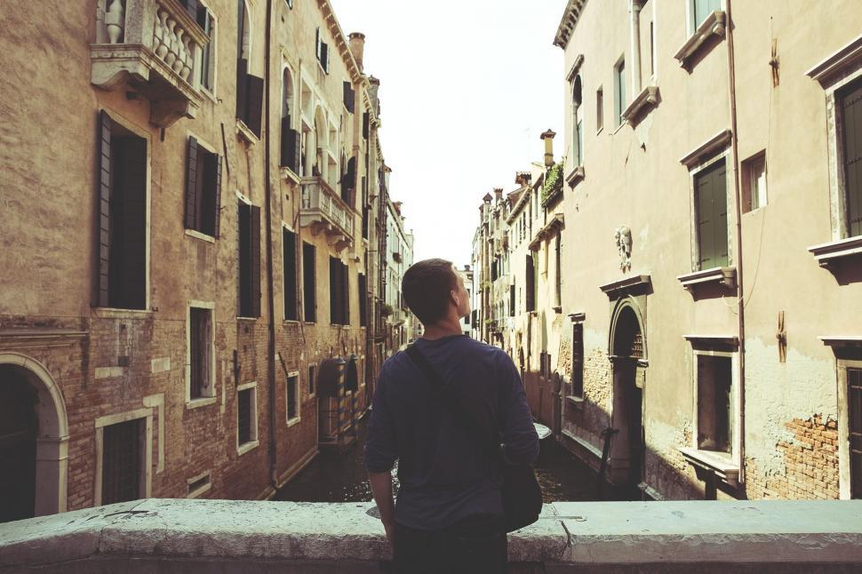 Free Image of Person Standing on Ledge in Narrow Alleyway 