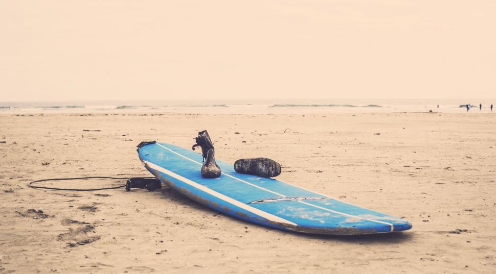 Free Image of Blue Surfboard on Sandy Beach 