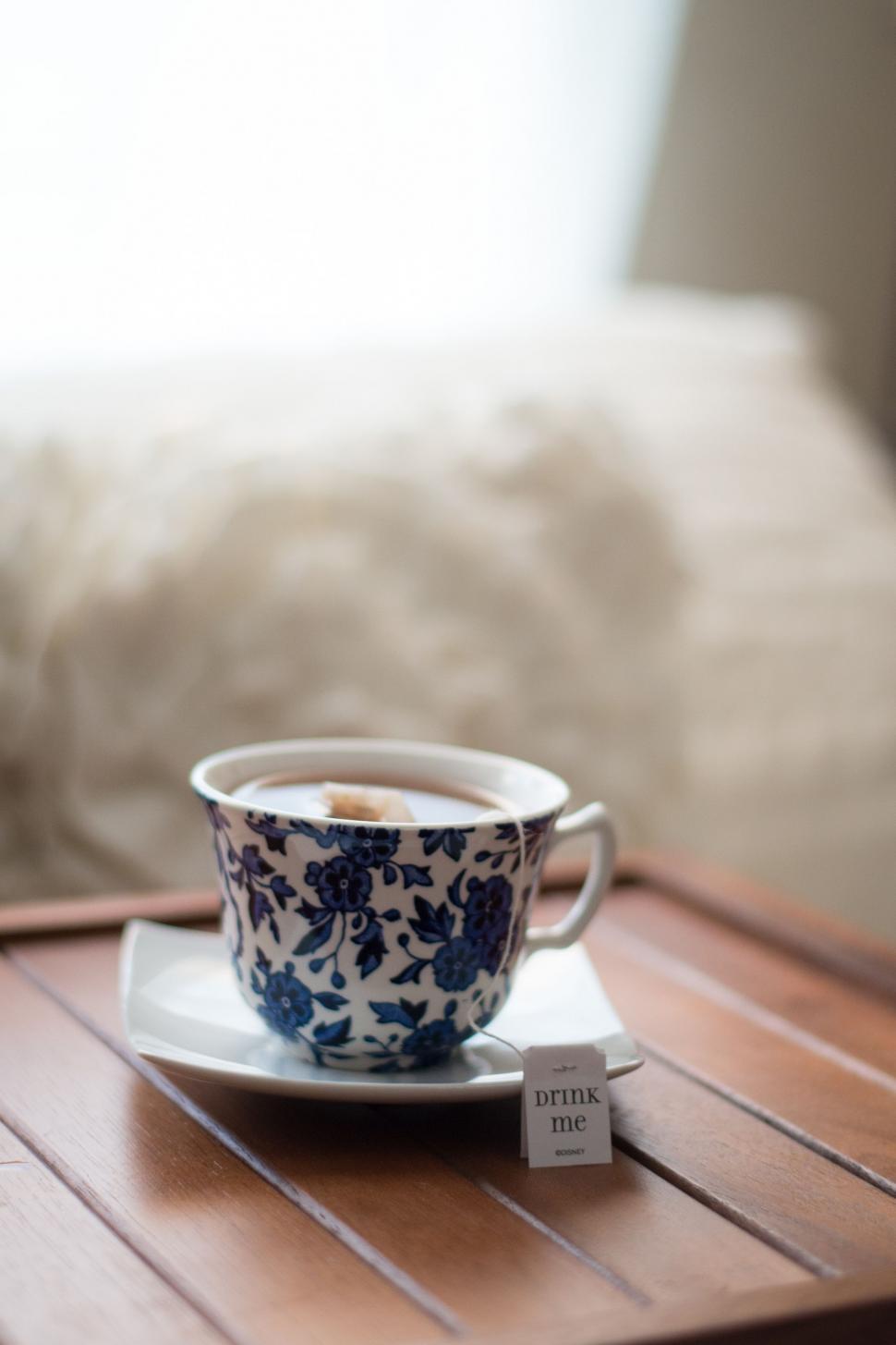 Free Image of Blue and White Tea Cup on Wooden Table 