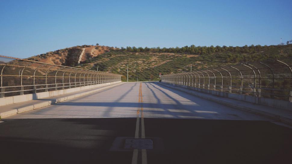 Free Image of A View of a Road Through a Fenced-in Area 