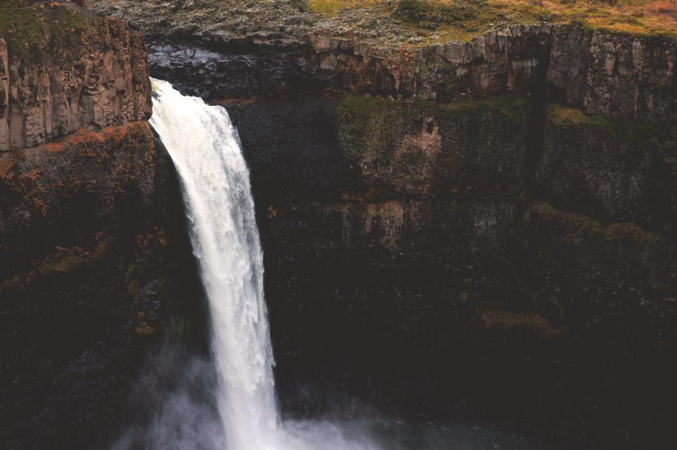 Free Image of Man Standing at the Top of a Waterfall 