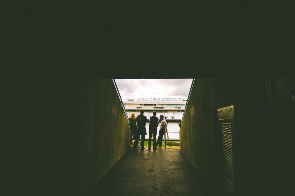 Free Image of A Group of People Walking Down a Hallway 