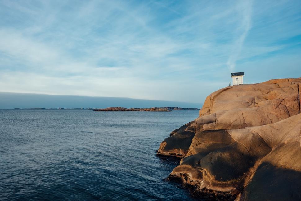 Free Image of Lighthouse on Rocky Outcropping by the Ocean 