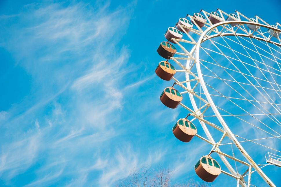 Free Image of Ferris Wheel Against Blue Sky With Clouds 
