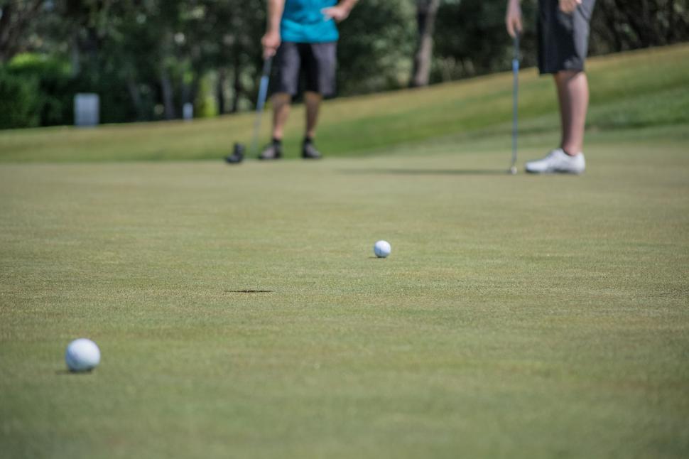 Free Image of Couple Playing Golf on the Course 