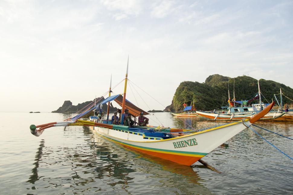 Free Image of Group of Boats Floating on Body of Water 