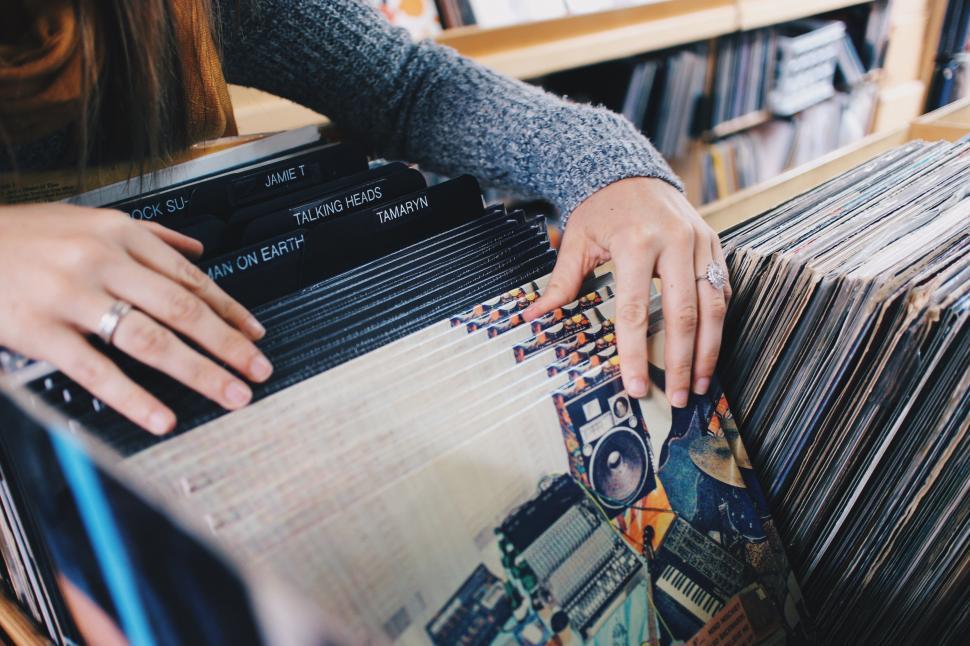 Free Image of Woman Holding Record Player in Record Shop 