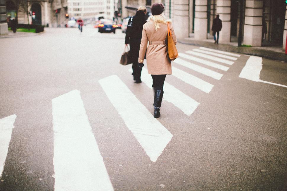 Free Image of Woman Walking Across Crosswalk in City 