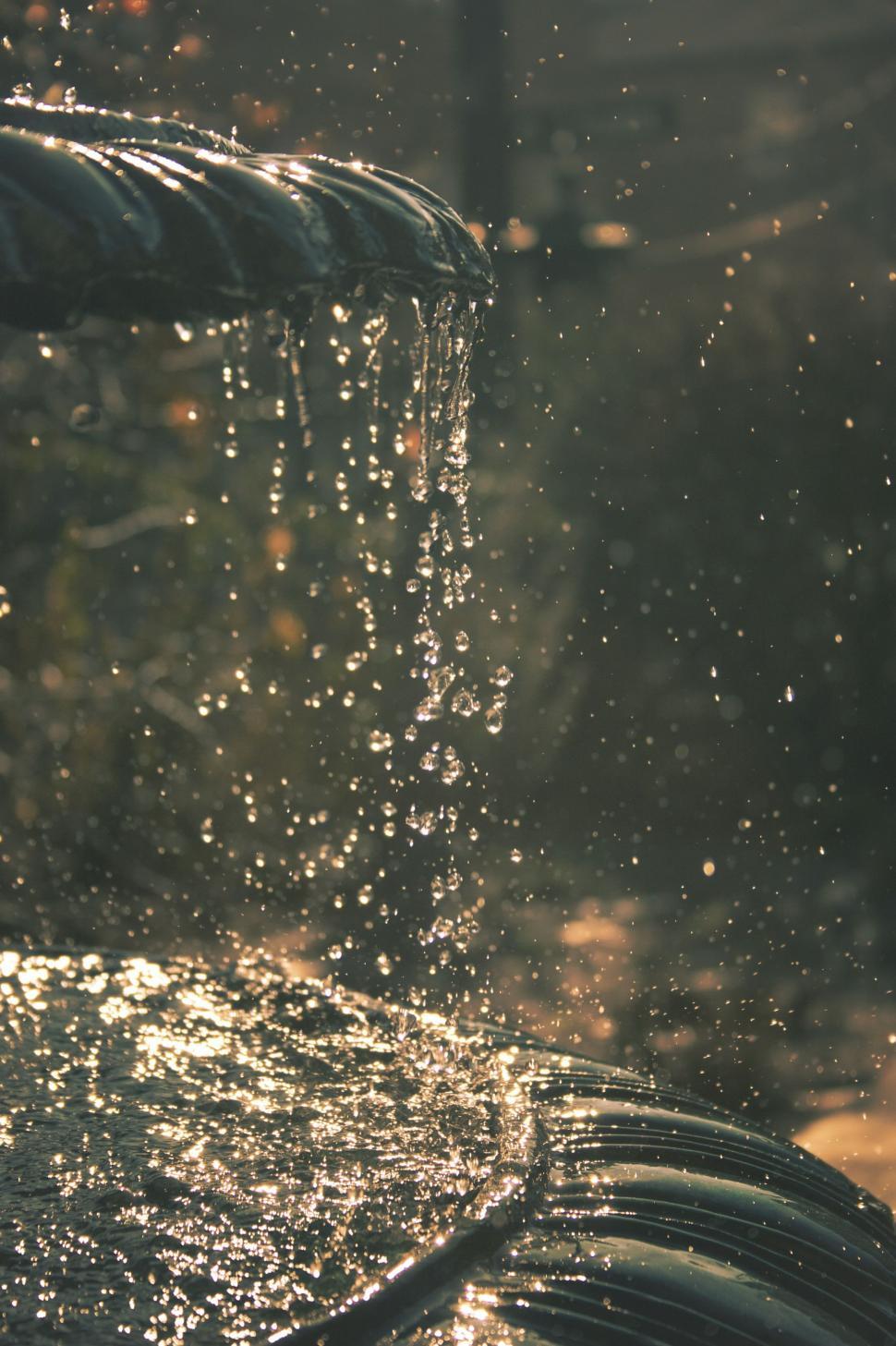 Free Image of A Close Up of a Water Faucet With Rain Coming Off 