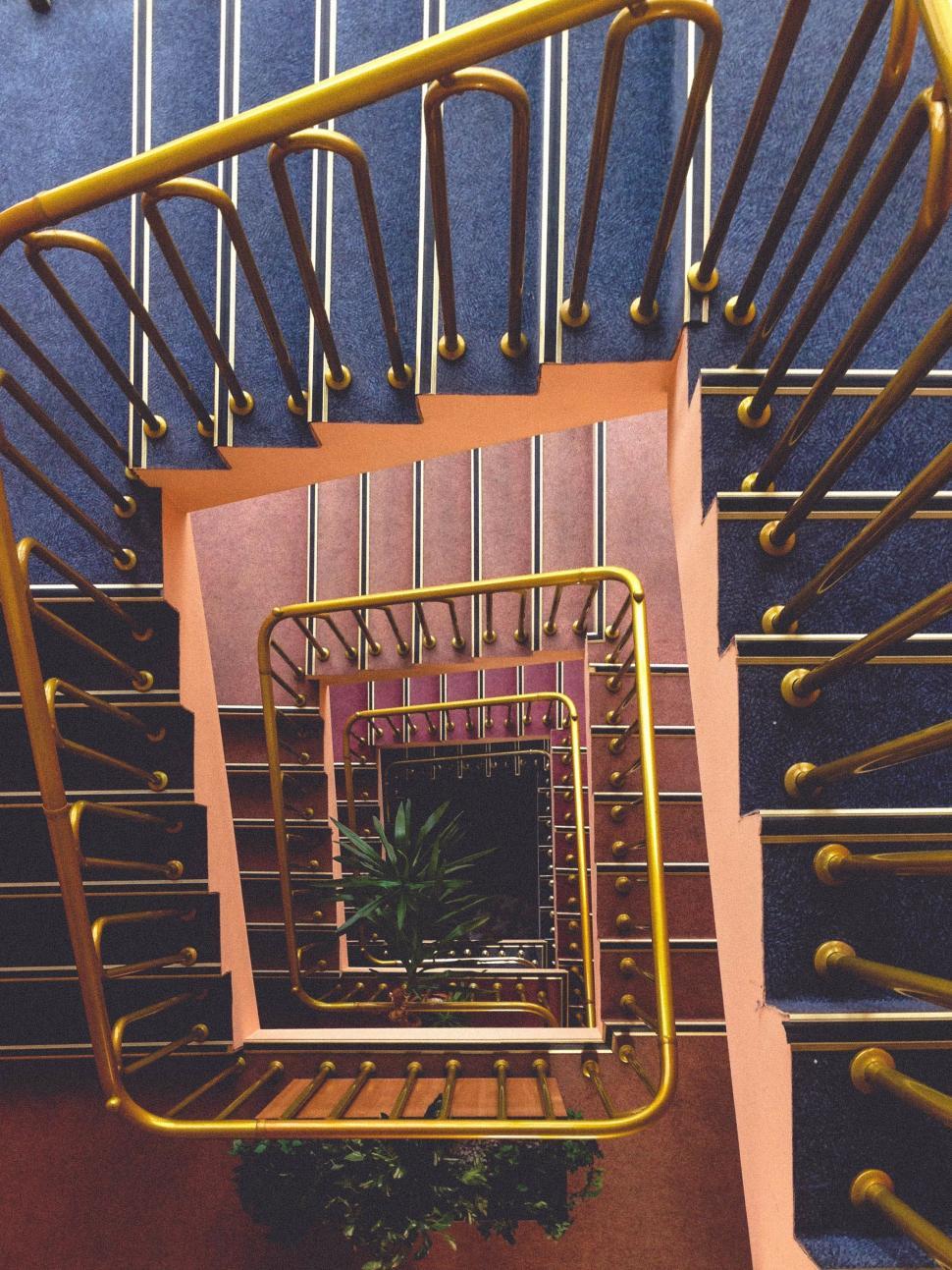 Free Image of Spiral Staircase With Central Plant 