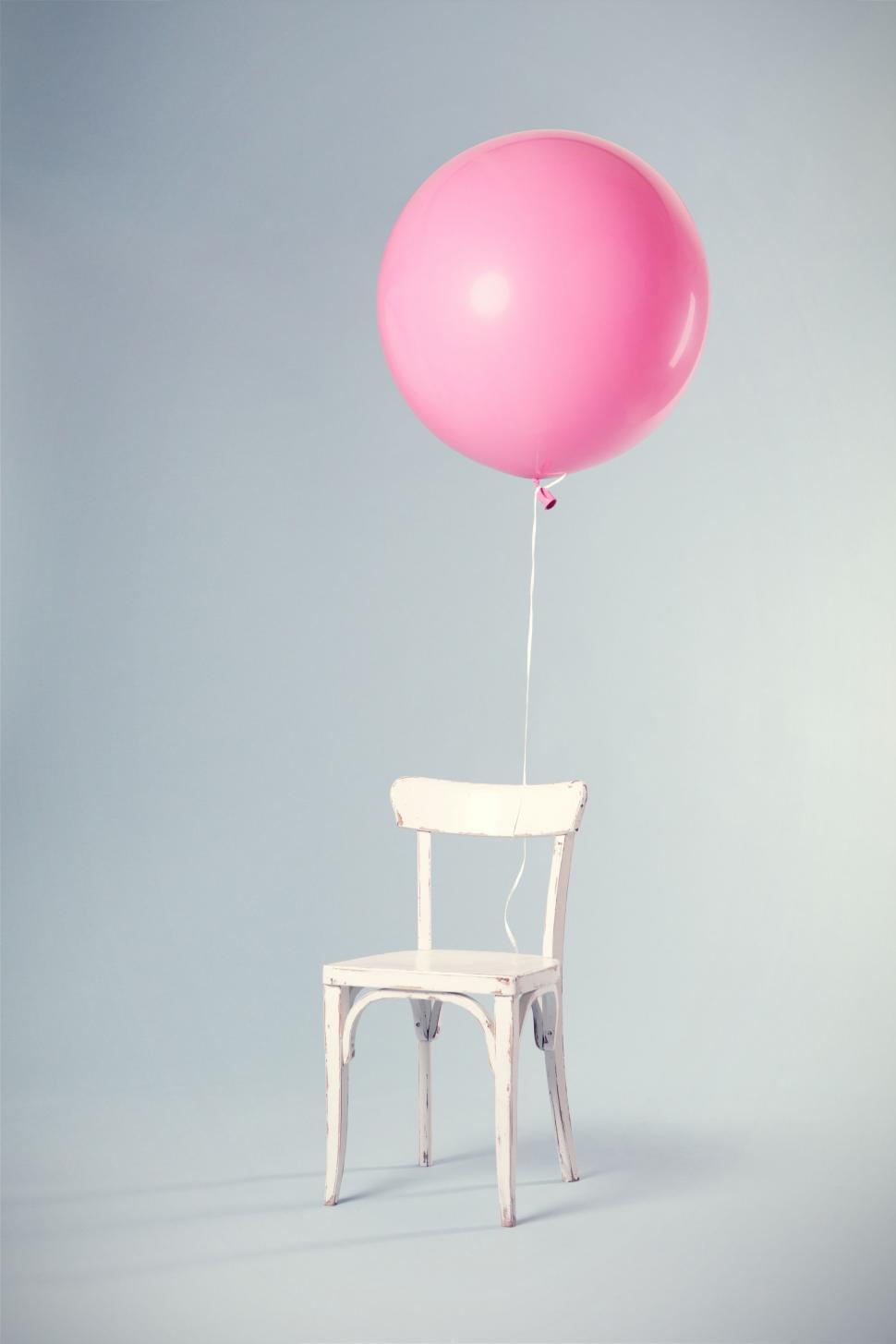 Free Image of White Chair With Pink Balloon 