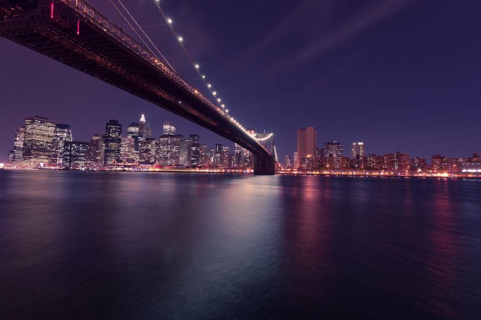 Free Image of Bridge Over a Body of Water at Night 