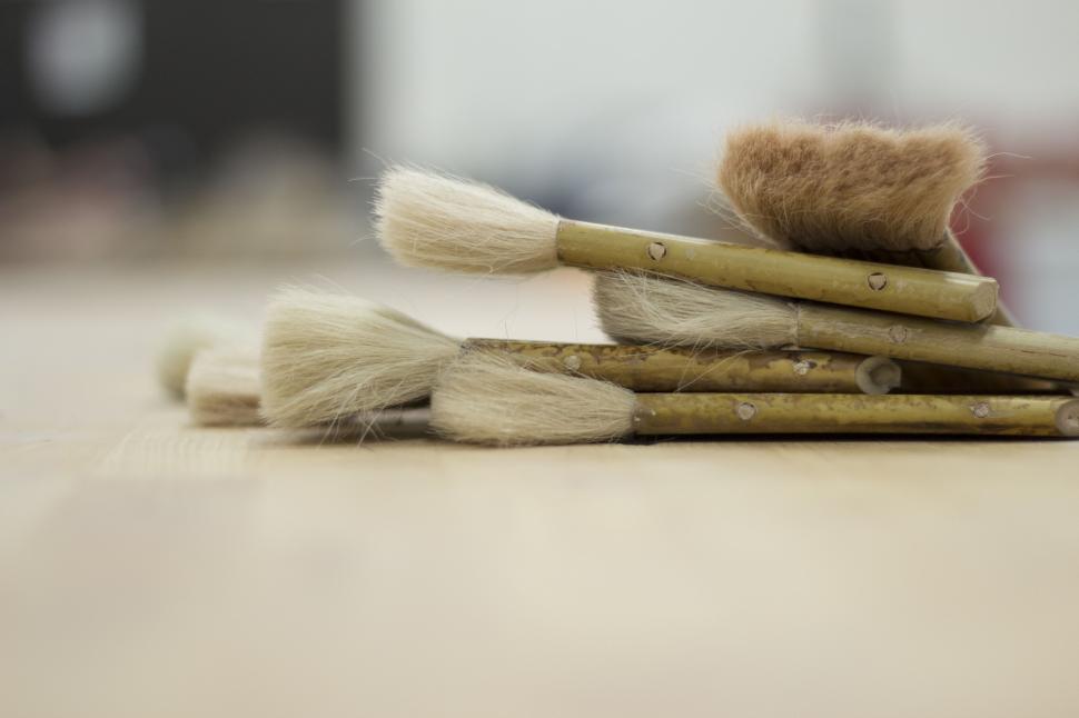 Free Image of Pile of Brushes on Wooden Table 