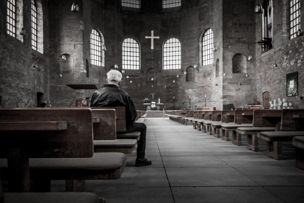 Free Image of Man Sitting on a Bench in a Church 