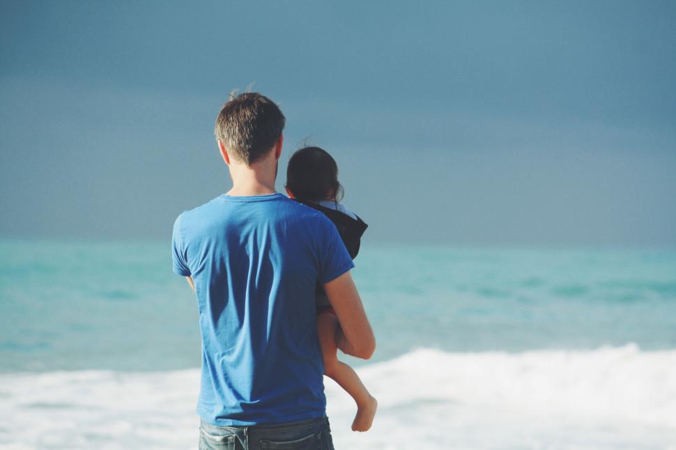 Free Image of Man Carrying Woman on His Back at the Beach 