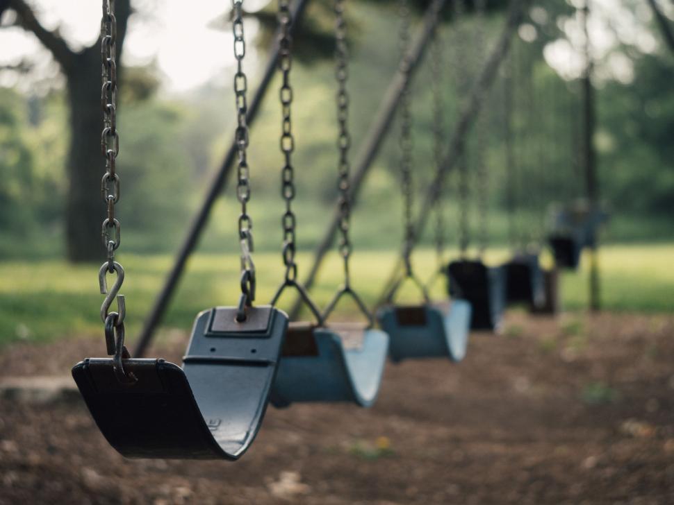 Free Image of Row of Swings in Park With Trees 