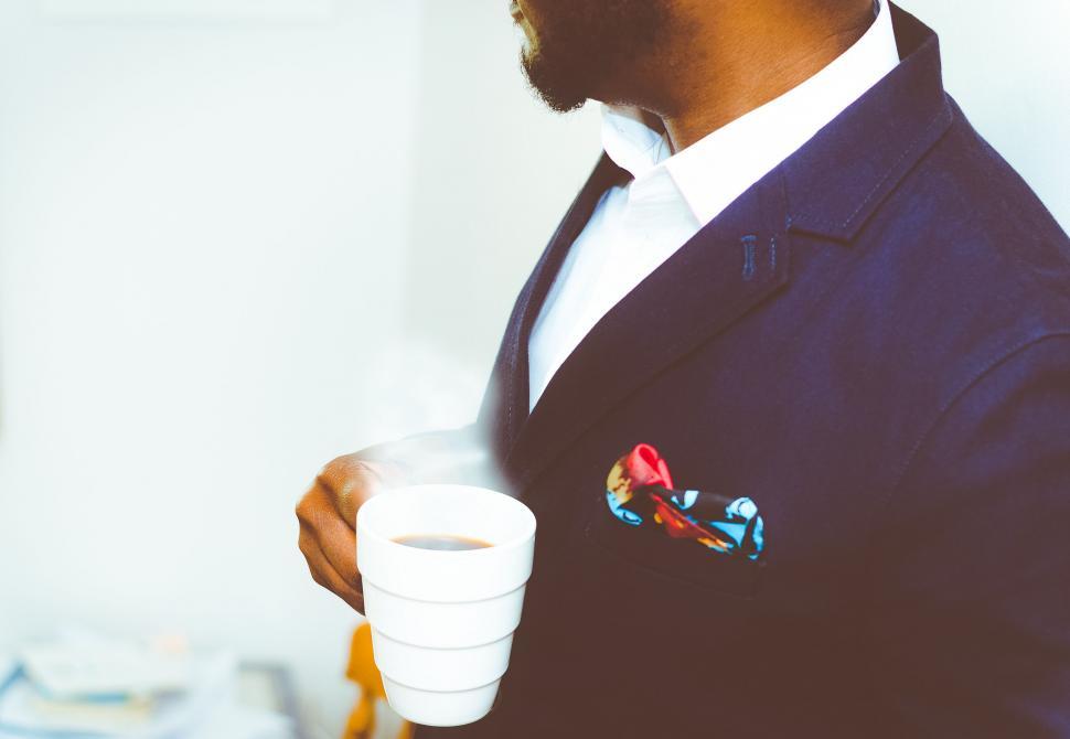 Free Image of Man in Suit Holding Cup of Coffee 