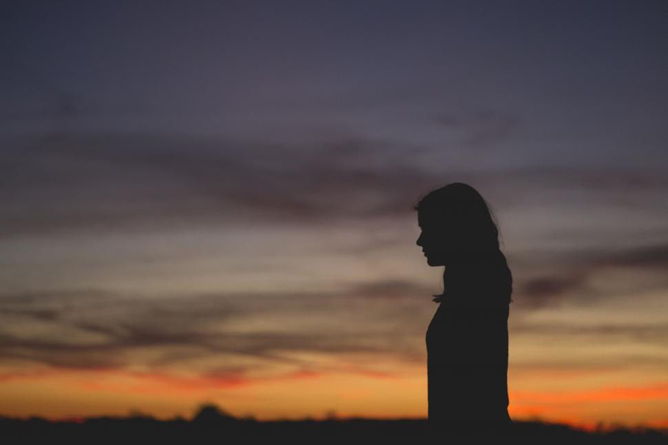 Free Image of Person Silhouetted Against Sunset 