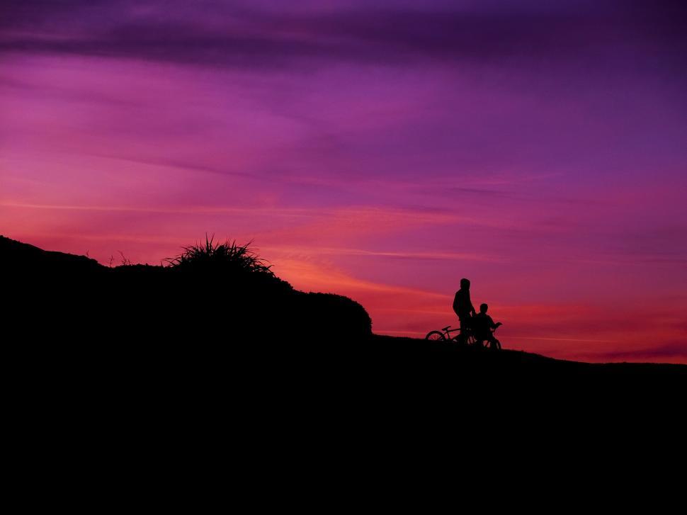 Free Image of Person Riding a Bike on a Hill at Sunset 