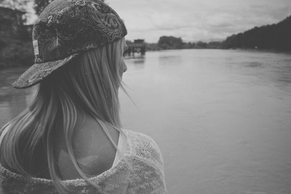 Free Image of Woman Standing on the Side of a River 