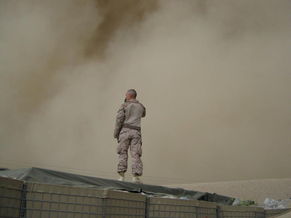 Free Image of Man Standing on Top of Roof 