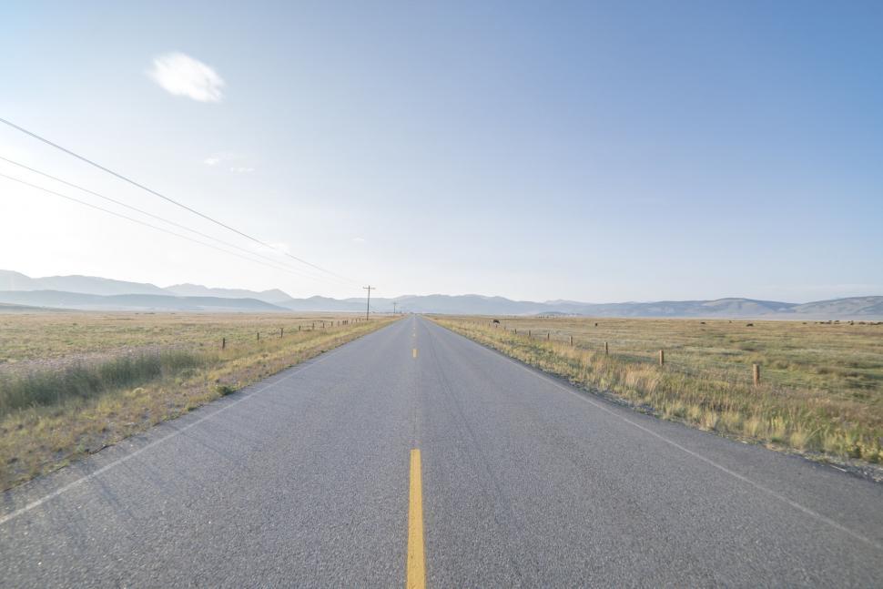 Free Image of Endless Highway Stretching Through Desolate Landscape 