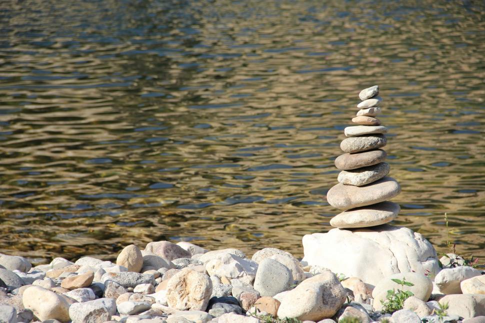 Free Image of Pile of Rocks Next to Body of Water 
