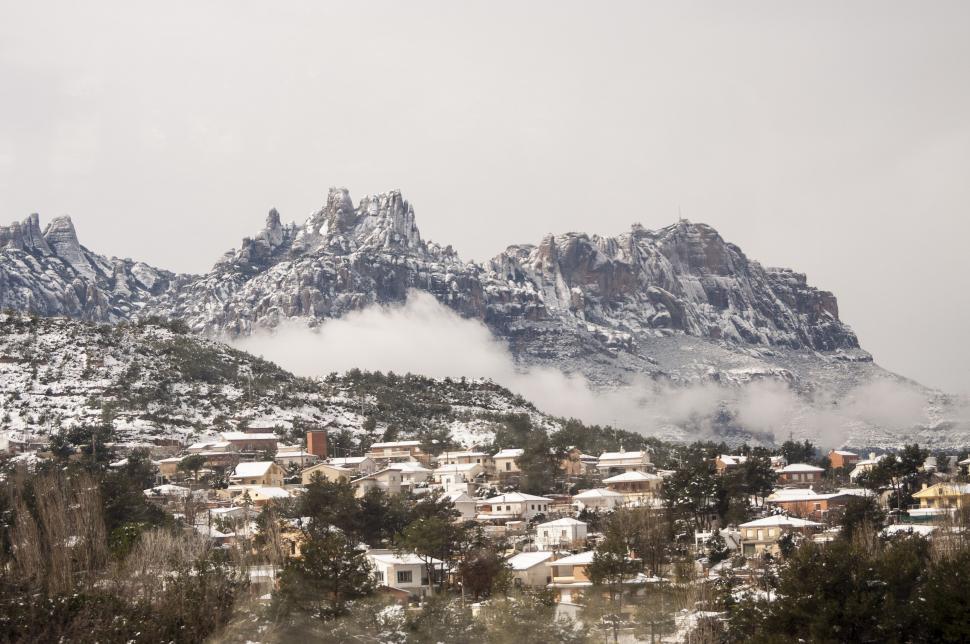 Free Image of Snow Covered Mountain Overlooking Town 