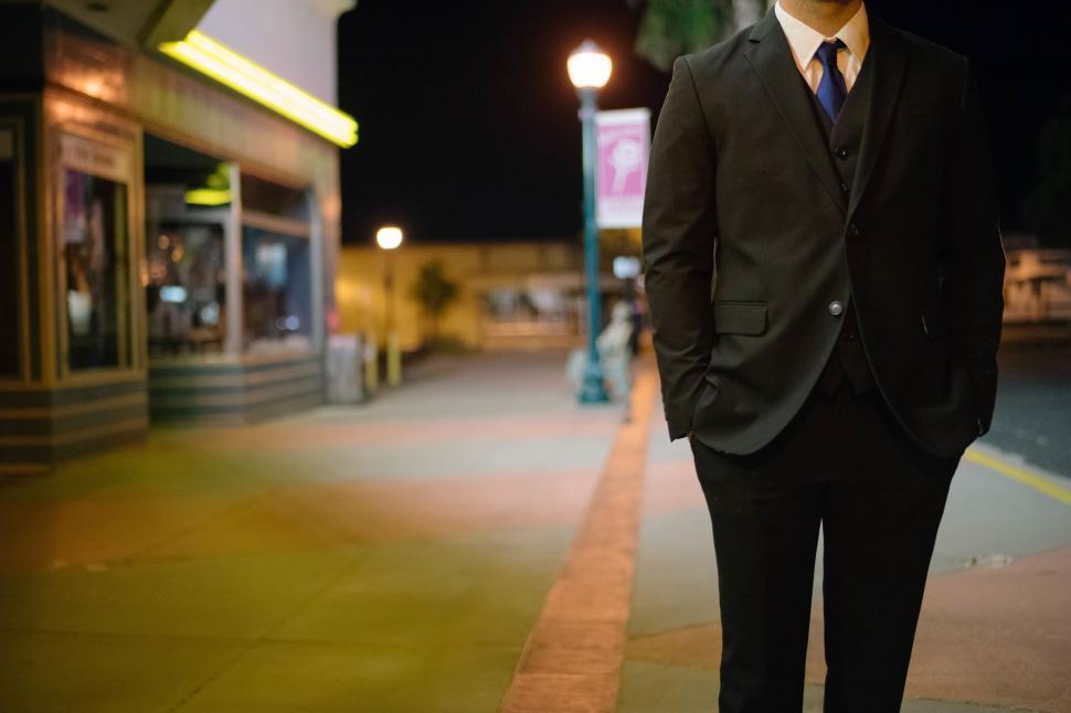 Free Image of Businessman in Suit and Tie Standing on Sidewalk 