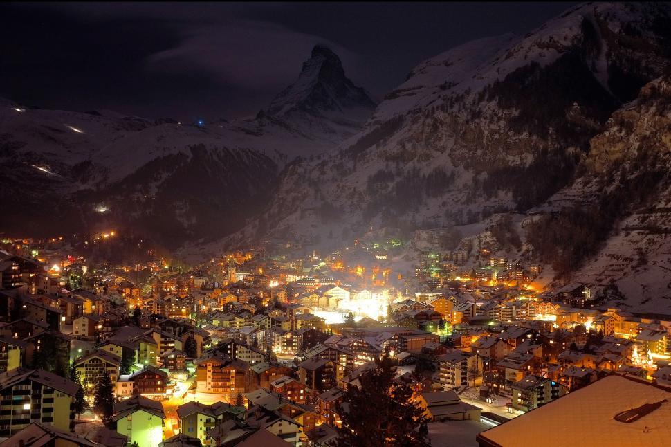 Free Image of Night View of City With Mountains in Background 