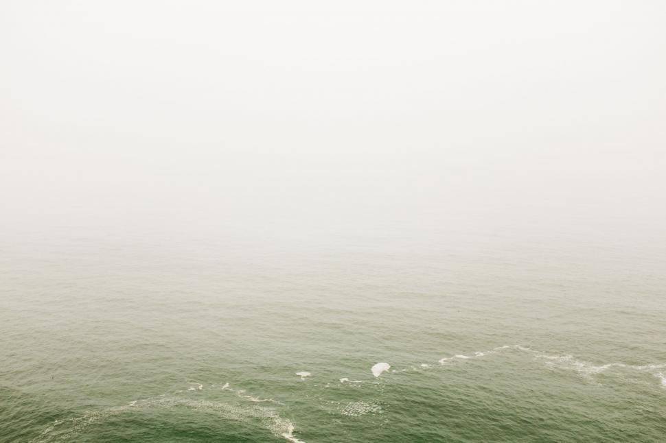 Free Image of Fog Envelops Large Body of Water 