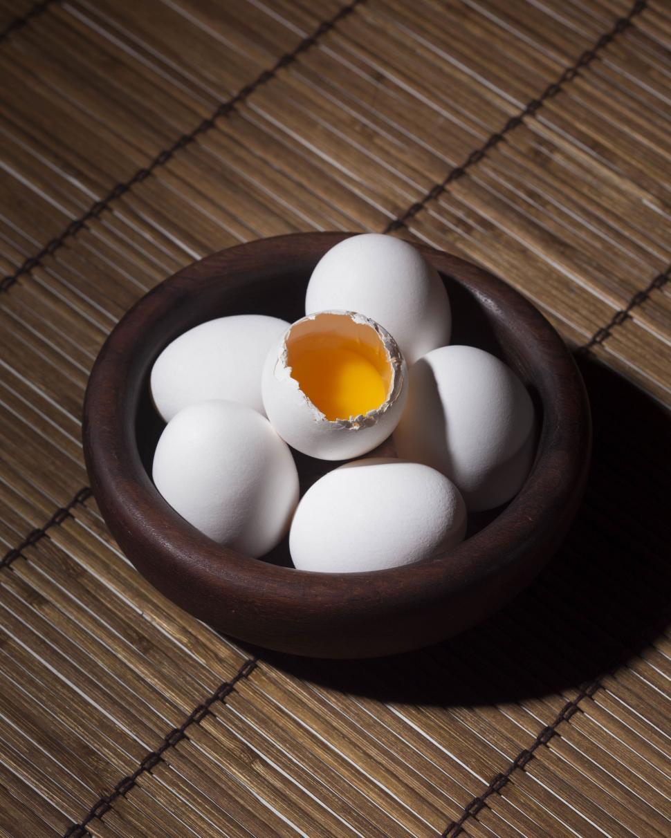 Free Image of Brown Bowl Filled With White Eggs on Bamboo Mat 