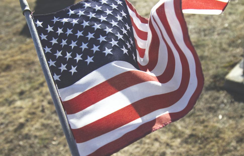 Free Image of Person Holding American Flag in Field 
