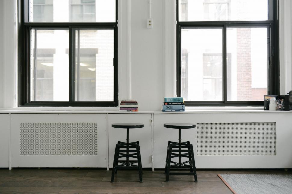Free Image of Two Black and White Stools in Front of a Window 