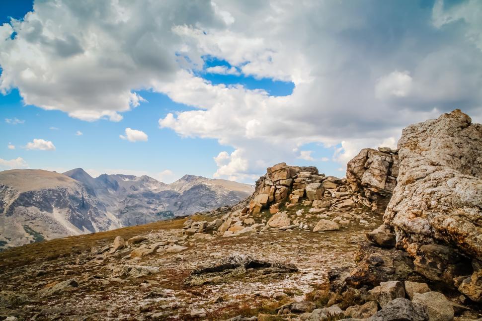 Free Image of Rocky Outcropping in the Mountains Under a Cloudy Sky 