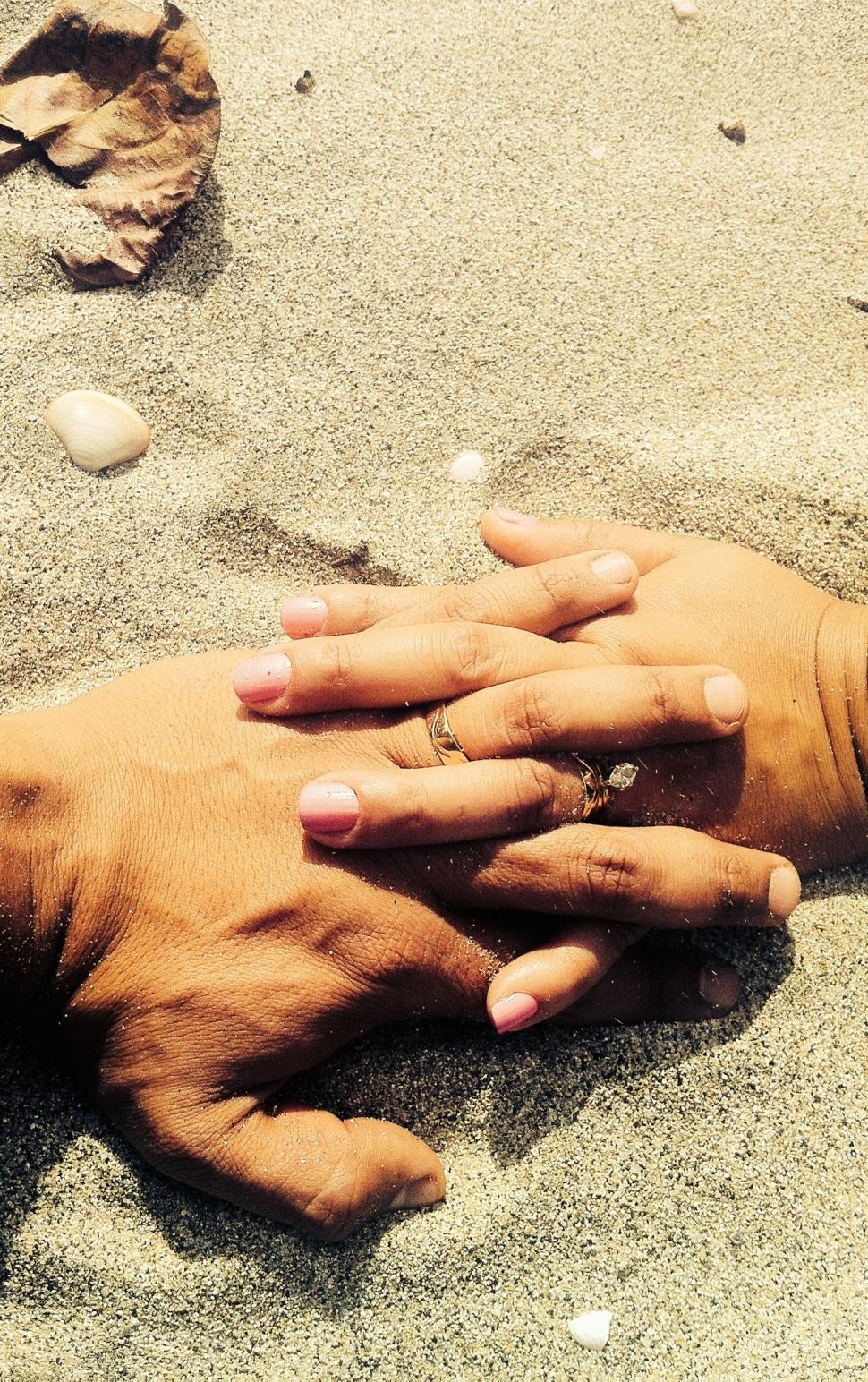 Free Image of Hands Holding Each Other in the Sand 