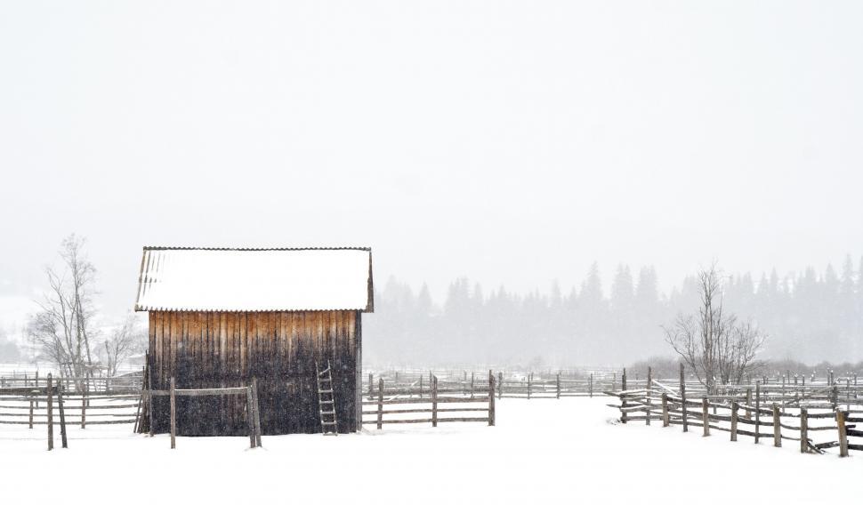 Free Image of Snow Covered Field With Barn and Fence 