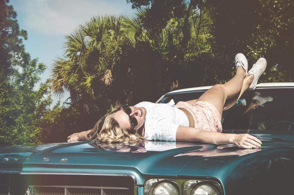 Free Image of Woman Laying on Hood of Car 