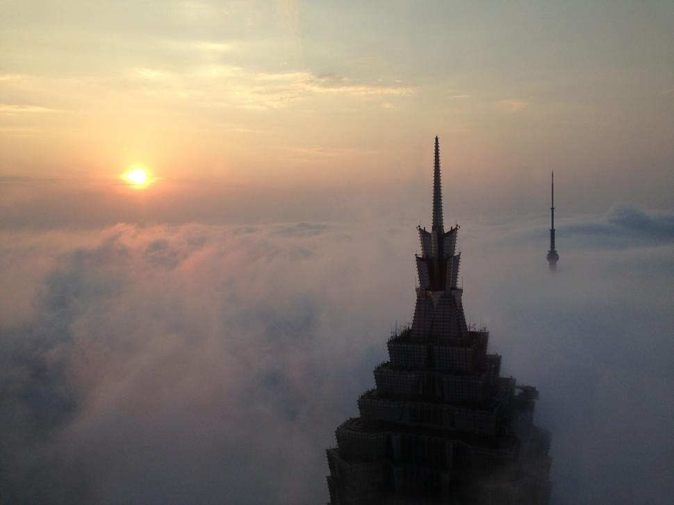 Free Image of Towering Skyscraper in Foggy Sky 