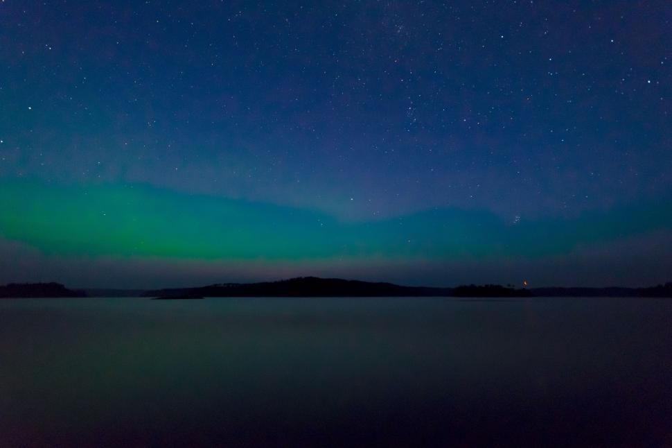 Free Image of Green and Blue Aurora Dancing Over a Body of Water 