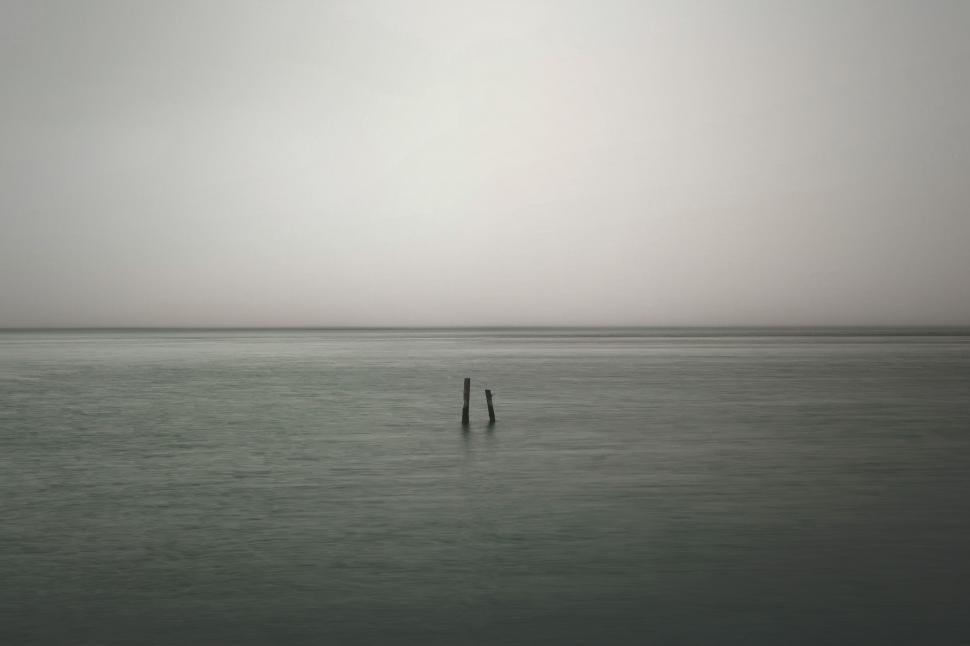 Free Image of Person Standing in Middle of Body of Water 