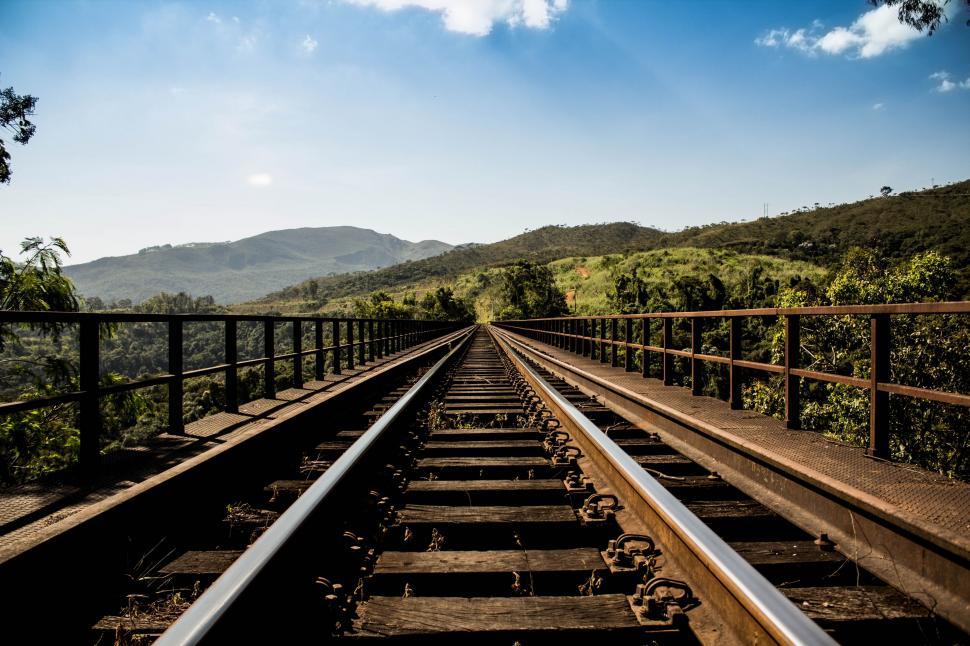Free Image of Train Track With Mountains in the Background 