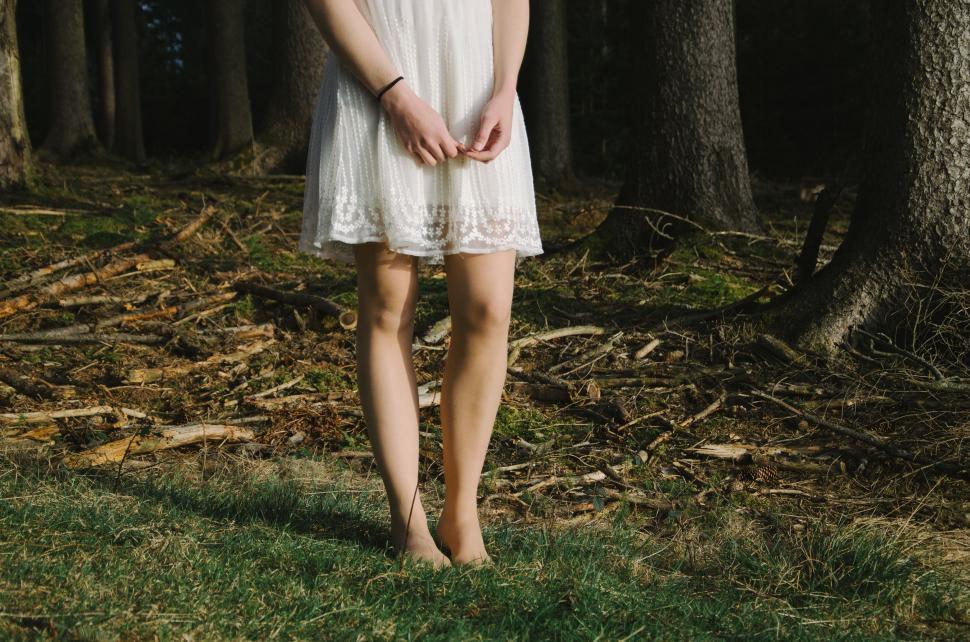 Free Image of Woman in White Dress Standing in Forest 