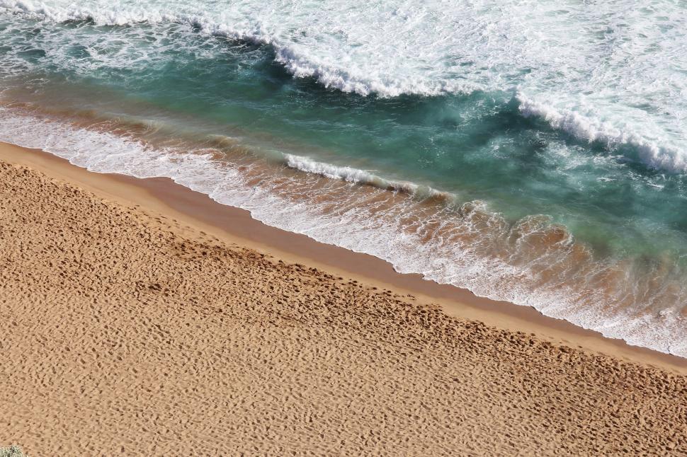 Free Image of A Birds Eye View of a Sandy Beach and Ocean 
