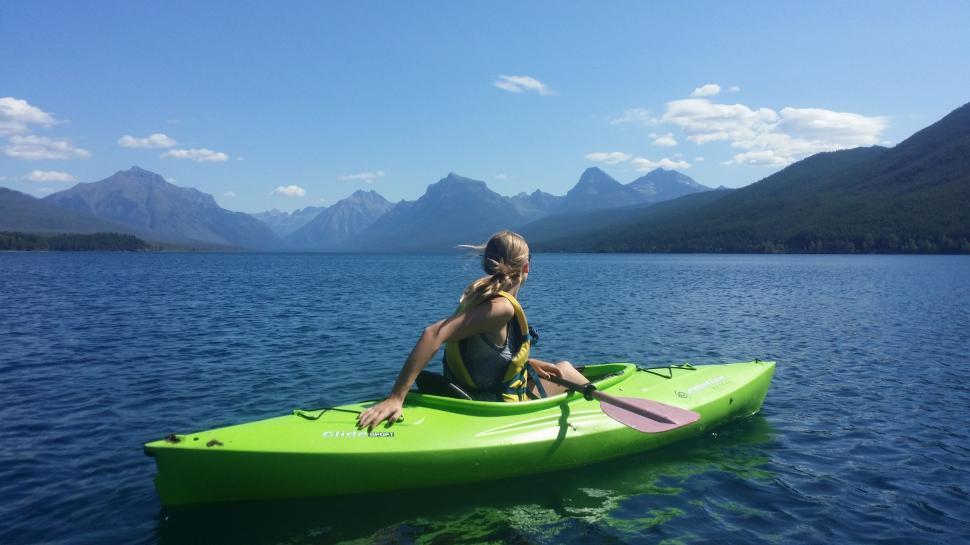Free Image of Woman Sitting in Green Kayak on Lake 
