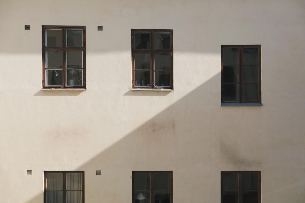 Free Image of Four Windows on a Black and White Building 