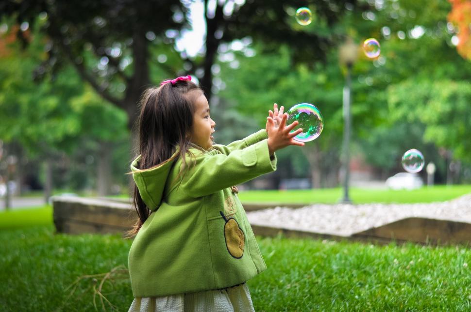 Free Image of Little Girl Playing With Bubbles in a Park 