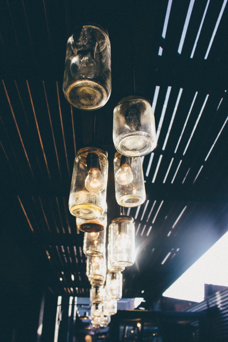 Free Image of Glass Bottle Chandelier Hanging From Ceiling 