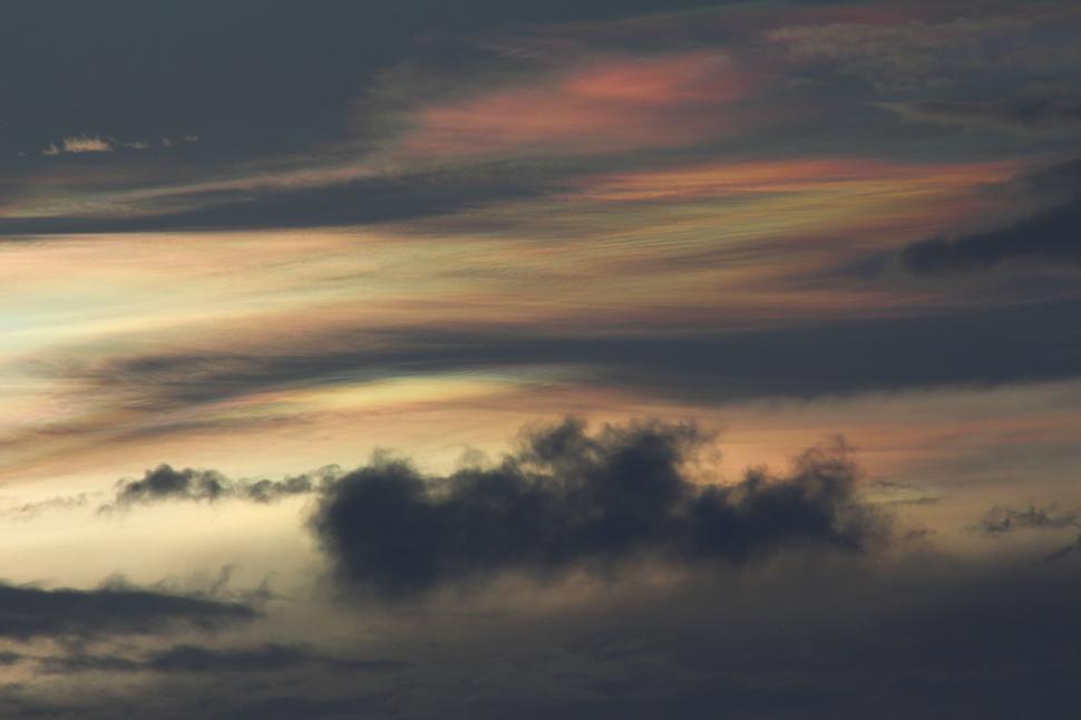 Free Image of Plane Flying Through Cloudy Sunset Sky 