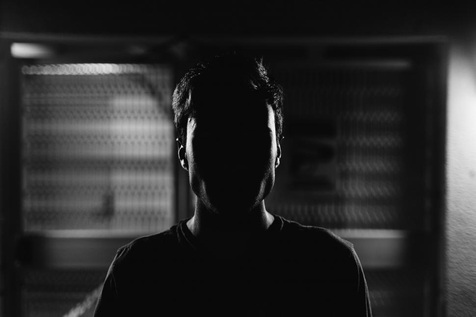Free Image of Man Standing in Front of Refrigerator in Dark Room 